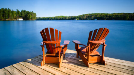 Adirondack chairs on a wooden pier