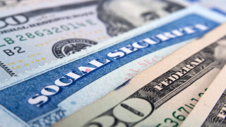 Close-up shot of Social Security card and dollar bills