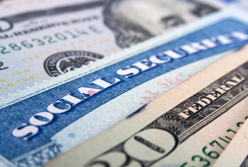 Close-up shot of Social Security card and dollar bills