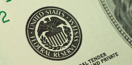 Close-up photo of the United States Federal Reserve System logo printed on a dollar bill