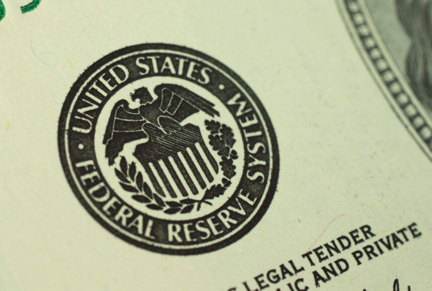 Close-up photo of the United States Federal Reserve System logo printed on a dollar bill