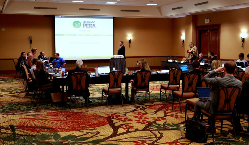 Members of the Colorado PERA Board of Trustees gather in a conference room
